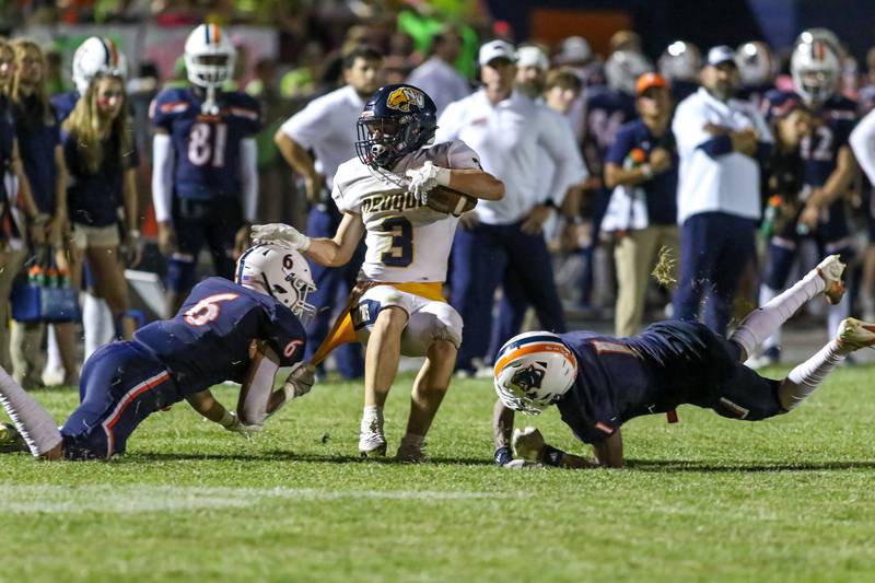 equa Valley's William Beaman (3) is tackled by Oswego's Mikey Claycombe (6) and Jeremiah Cain (1) during a football game between Neuqua Valley and Oswego on Friday, Aug. 30, 2024 in Oswego. Gary E Duncan Sr for Shaw Local News Network.