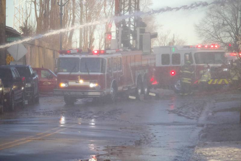 Joliet firefighters at the scene of a fire at an old commercial building on Thursday, Jan. 29, 2026, at the corner of South Eastern Avenue and Washington Street in Joliet.