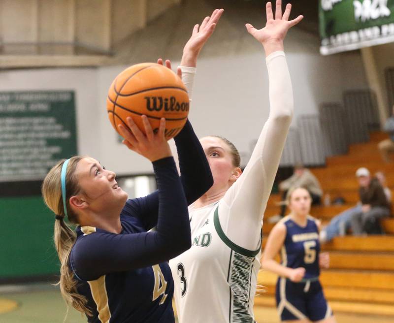 Marquette's Hunter Hopkins eyes the hoop as Midland's Anna McGlasson defends on Thursday, Feb. 12, 2026 at Midland High School.