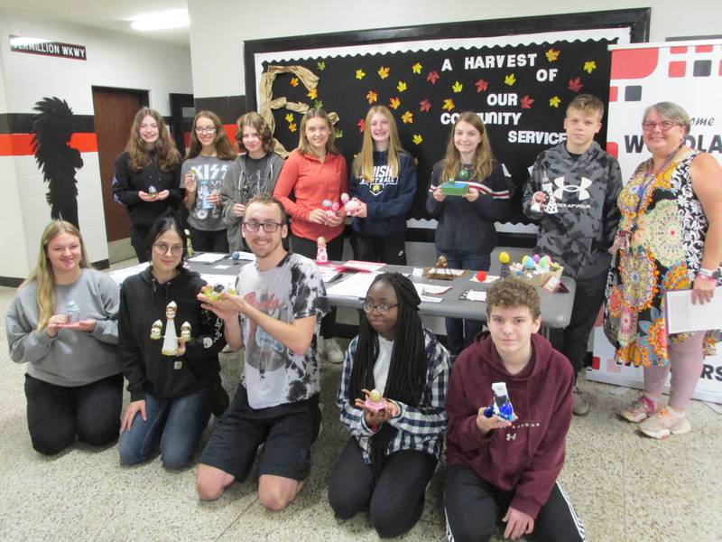 Woodland High School art teacher Susan Trammel (top right) has her class show off their Faberge egg creations Thursday, Nov. 3, 2022.