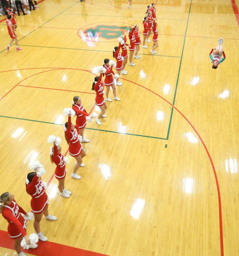 Ottawa cheer eaders perform on the floor as an L-P cheerleader does back flips in front of them on Friday, Feb. 7, 2025 in Sellett Gymnasium at L-P High School.