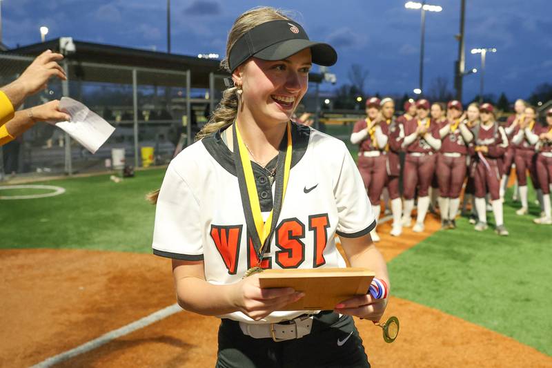 Lincoln-Way West’s Kaylea Armstrong receives the tournament MVP plaque after the Warriors 11-1 win over Lockport in the WJOL Softball Tournament championship game on Thursday, April 2, 2026 in Joliet.