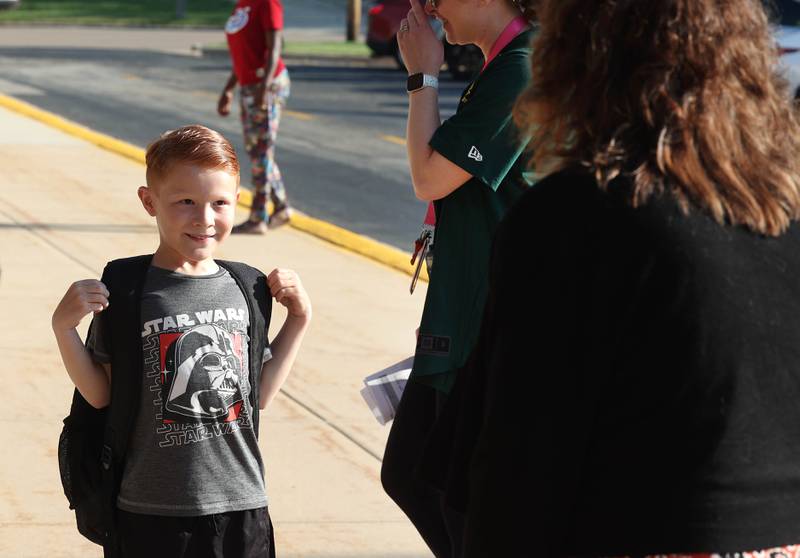 Oliver Nadeau, a first grader, talks to DeKalb School District 428 Superintendent Minerva Garcia-Sanchez Wednesday, Aug. 13, 2025, as he arrives for the first day of school at Founders Elementary in DeKalb.
