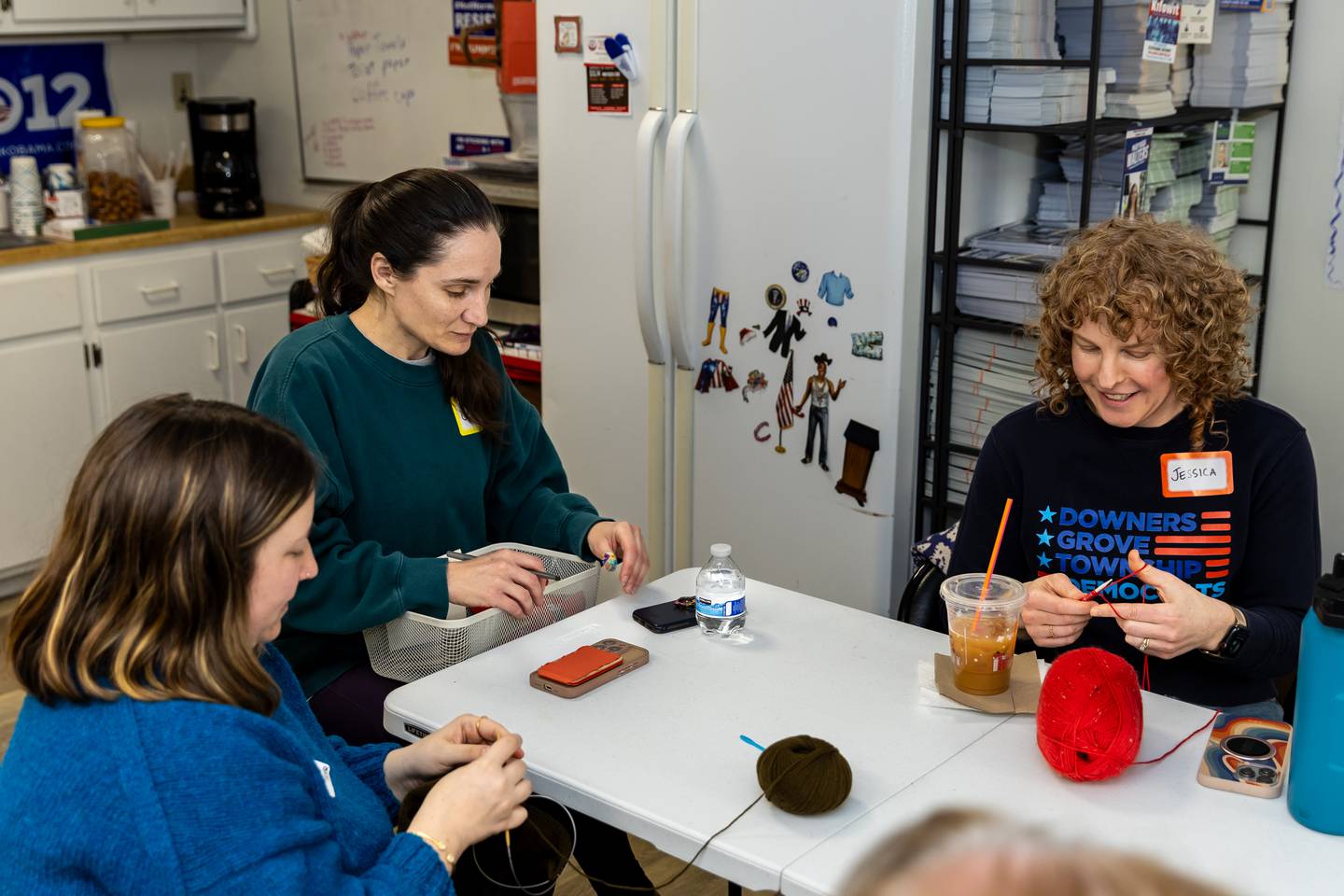 Maggie Bonetti (left), Jessica Modderman, and Jessica O’Malley enjoy the Melt the ICE Hat Knit-Along event Sunday in Downers Grove