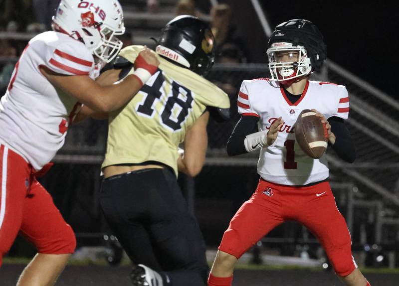 Ottawa’s Mark Munson looks for a receiver as Sycamore's Vincent Pitstick applies pressure during their game Friday, Sept. 27, 2024, at Sycamore High School.
