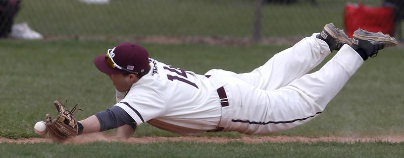 Prairie Ridge's Aidan Preves dives for the ball as he tries to catch a bunt during a Fox Valley Conference baseball game Friday, April 29, 2022, between Prairie Ridge and Jacobs at Prairie Ridge High School.