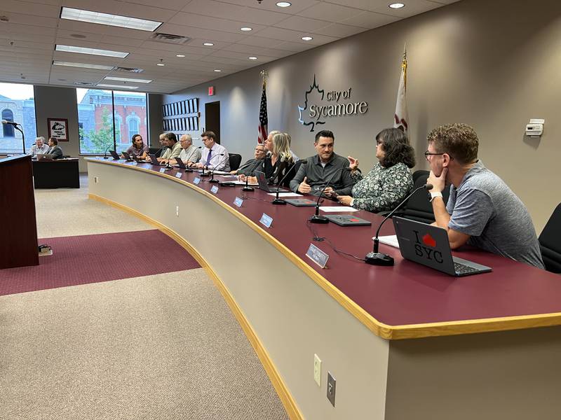 Third ward Alderperson, Jeff Fischer (third from right) talks with third ward Alderperson, Nancy Cobble (second from right) while fourth ward Alderperson, David Stouffer (right) listens before the city of Sycamore's Aug. 15, 2022 city council meeting.