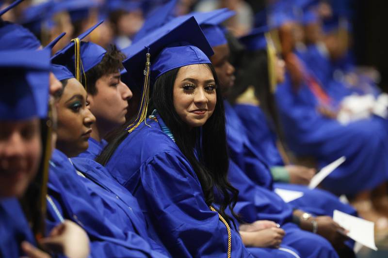 A graduate smiles at a friend at the Joliet Central Class of 2023 Commencement Ceremony on Saturday, May 20, 2023, in Joliet.