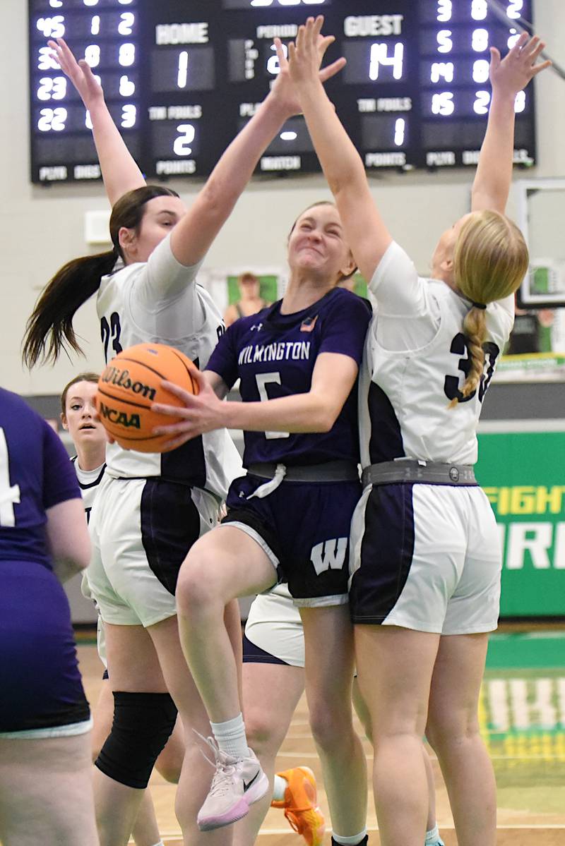 Wilmington's Keeley Walsh, center, goes for a layup between Manteno's Maddie Gesky, left, and Kendall Blanchette during the IHSA Class 2A Seneca Regional championship Thursday, Feb. 19, 2026.