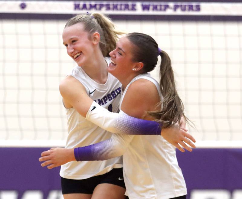 Hampshire’s Elizabeth King, left, and Kylie Lambert celebrate a point in their two-set win over Huntley in varsity girls volleyball at Hampshire High School in Hampshire on Tuesday, Sept. 23, 2025.