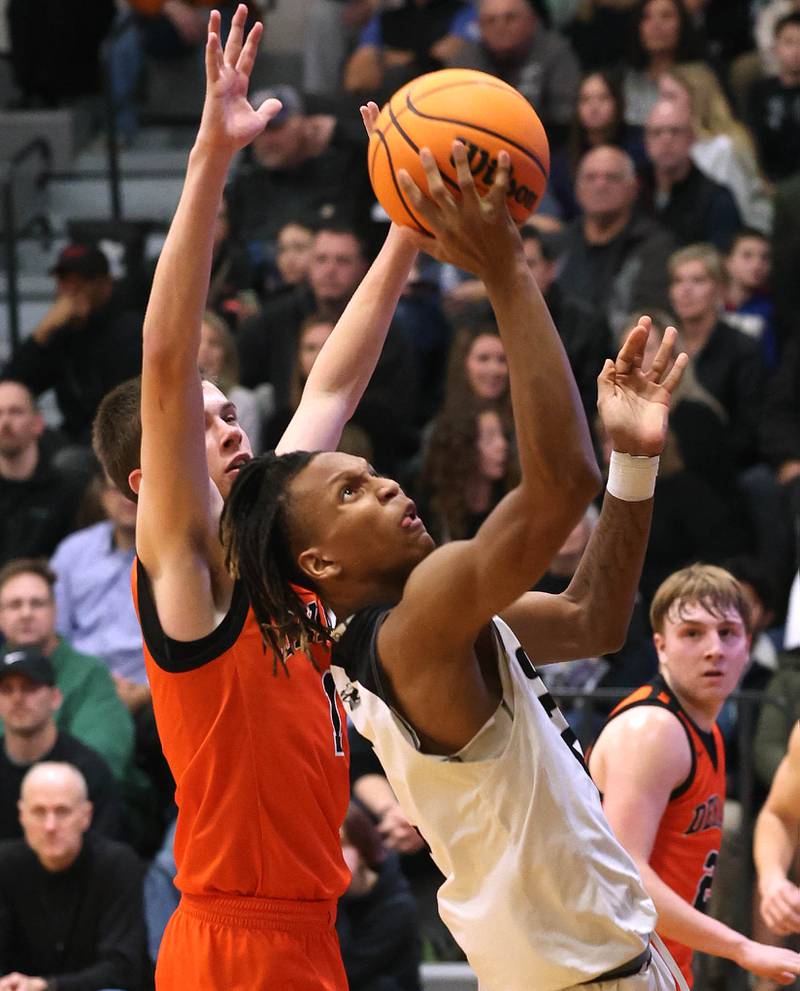 Kaneland's Isaiah Gipson tries to score in front of DeKalb's Jackson Kees during their game Tuesday, Jan. 28, 2025, at Kaneland High School in Maple Park.