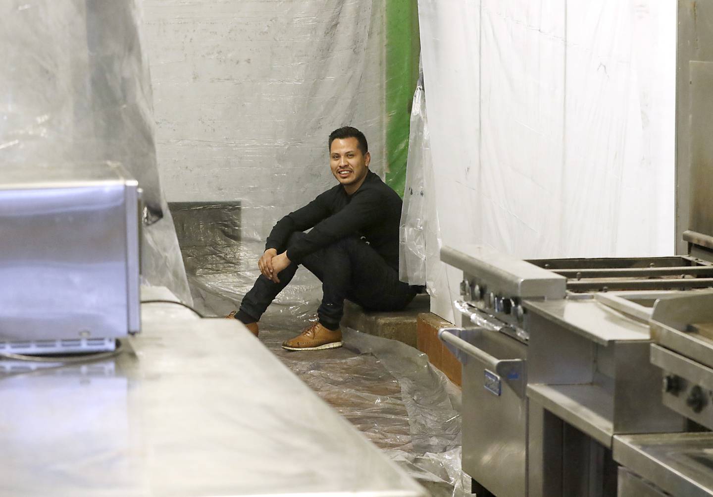 Raul Briseno Jr., the son of the late Raul Briseno Sr., sits Tuesday, Feb. 22, 2022, where he used to watch his dad prepare food when he was a child. Raul Briseno Jr. is opening up his own restaurant with is sister, Alexandra Strohmaier, in the original location where his dad opened up his first Raul’s Burrito Express in Wauconda. It has been 21 years since his father was murdered at the Burrito Express he owned in McHenry.