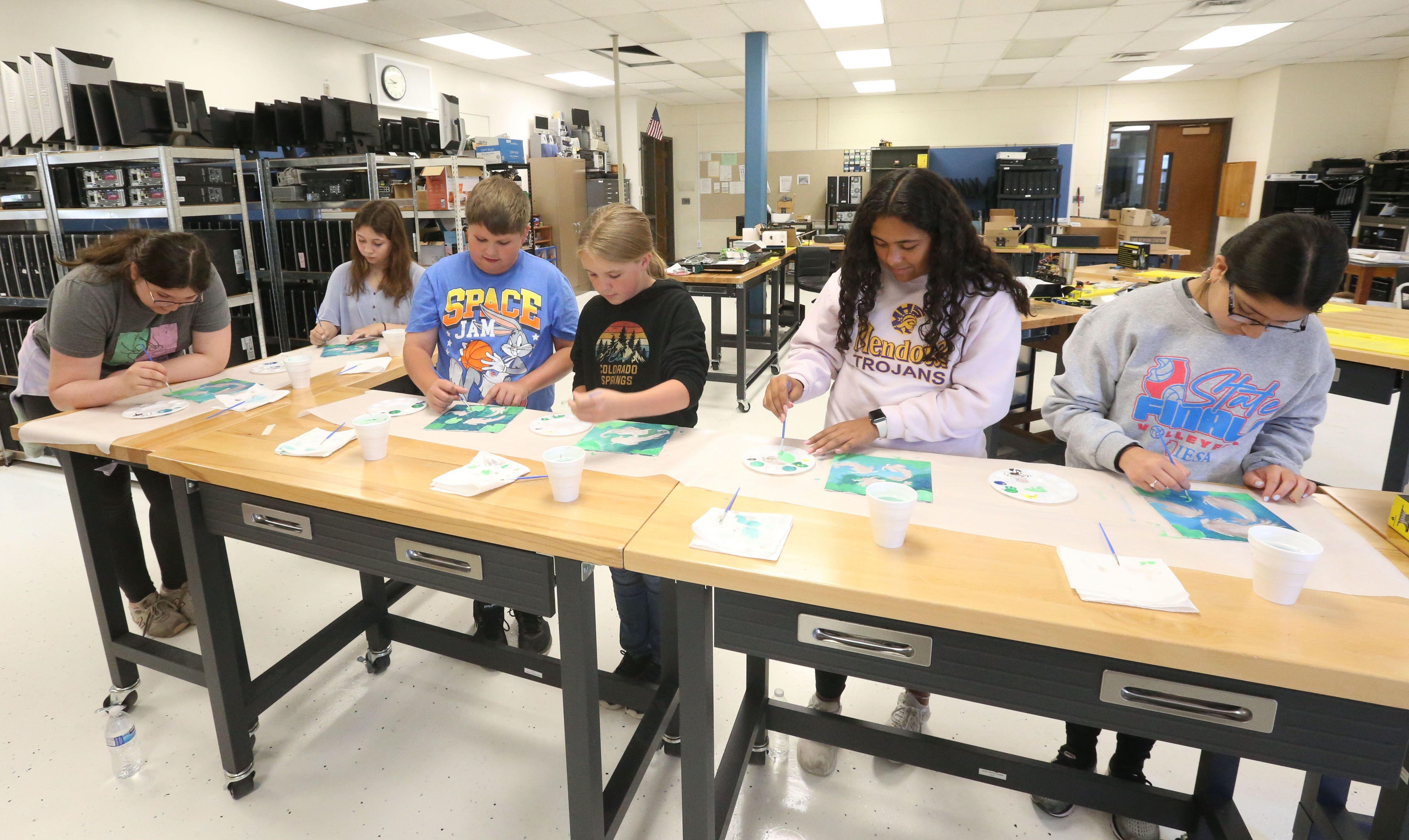 Sixth, seventh and eighth grade students color paintings in the graphic design class during the Area Career Center's Summer Hands-On Showcase on Thursday, June 8, 2023, at La Salle-Peru High School. 
