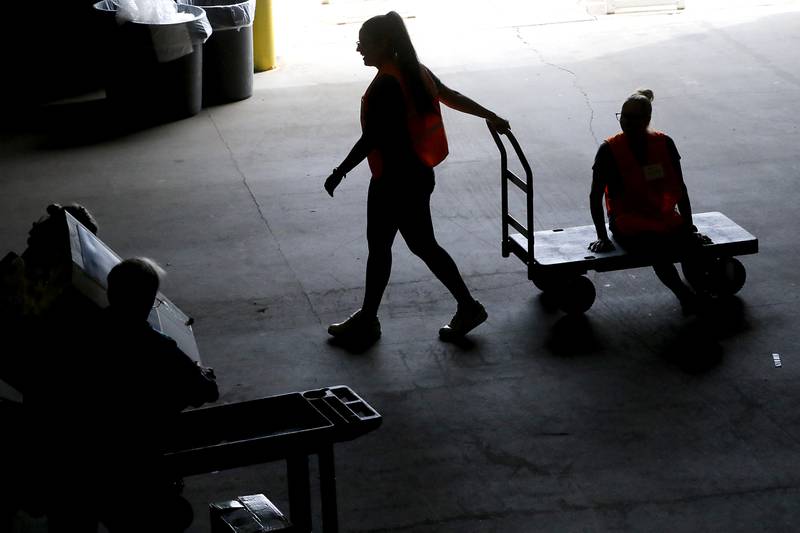 A worker gets a ride back to the unsorted items as McHenry County Department of Health staff and volunteers from the McHenry County Medical Reserve Corp sort items during the Operation Dropbox Exercise on Tuesday , June 11, 2024, at the McHenry County Division of Transportation near Woodstock. The training exercise simulates the process of unloading and distributing medical counter-measures during emergencies along with helping to sort and distribute the donated items to veterans and their families in the county.