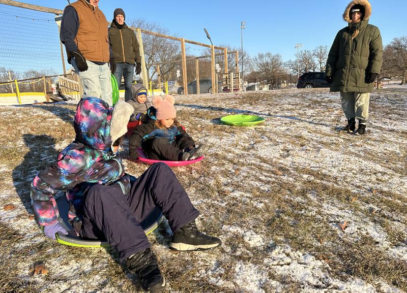 Eliana, Amari, and Josiah Orellana, ages 11, 5, and 3 of Naples, Florida, head down the hill at Winter Park in Morrison on Friday, Jan. 3, 2025. The Orellana family was visiting relatives in Morrison and wanted to try sledding following the dusting of snow that fell across the region.