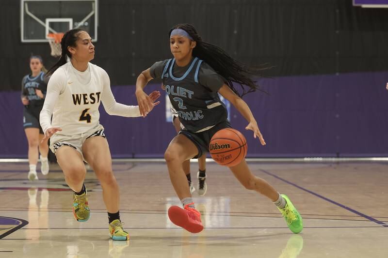 Joliet Catholic’s Layla Pierce drives to the basket against Joliet West in the WJOL Basketball Tournament at Joliet Junior College Event Center on Monday