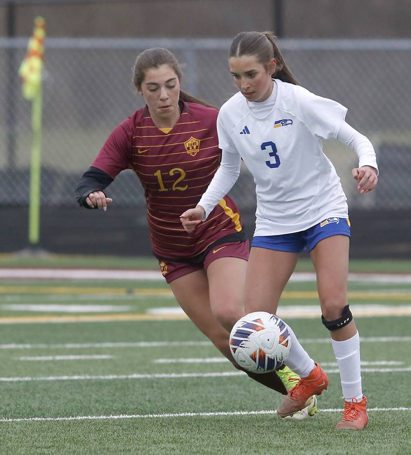 Johnsburg's Charlie Eastland controls the ball in front of Richmond-Burton's Nicole Mendlik during a Kishwaukee River Conference soccer game on Tuesday, April 1, 2025, at Richmond-Burton High School.