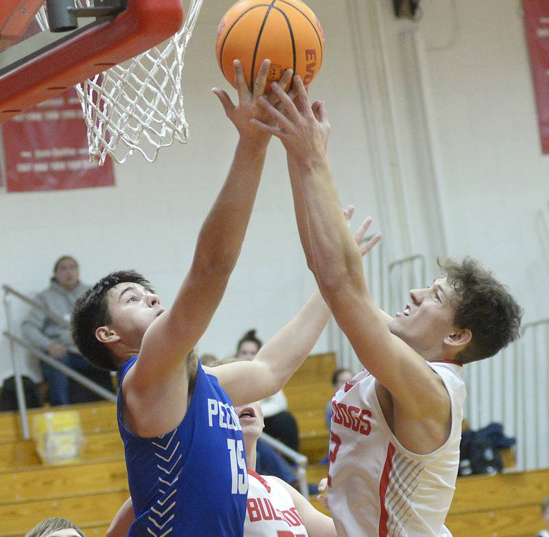 Peotone’s Ruben Velasco and Streator’s Matt Williamson fight for a rebound in the 2nd Period Tuesday at Streator.