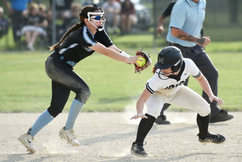 Kankakee's Adleigh Cunningham, left, reaches out to tag Bishop McNamara's Camille Czako during a game at Bishop McNamara Tuesday, May 13, 2025.