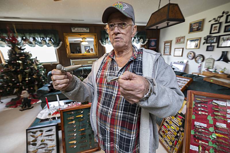 Reap shows off two of his oldest lures. The one on the left was made in Indiana in 1860 and on the right 1822 in England.