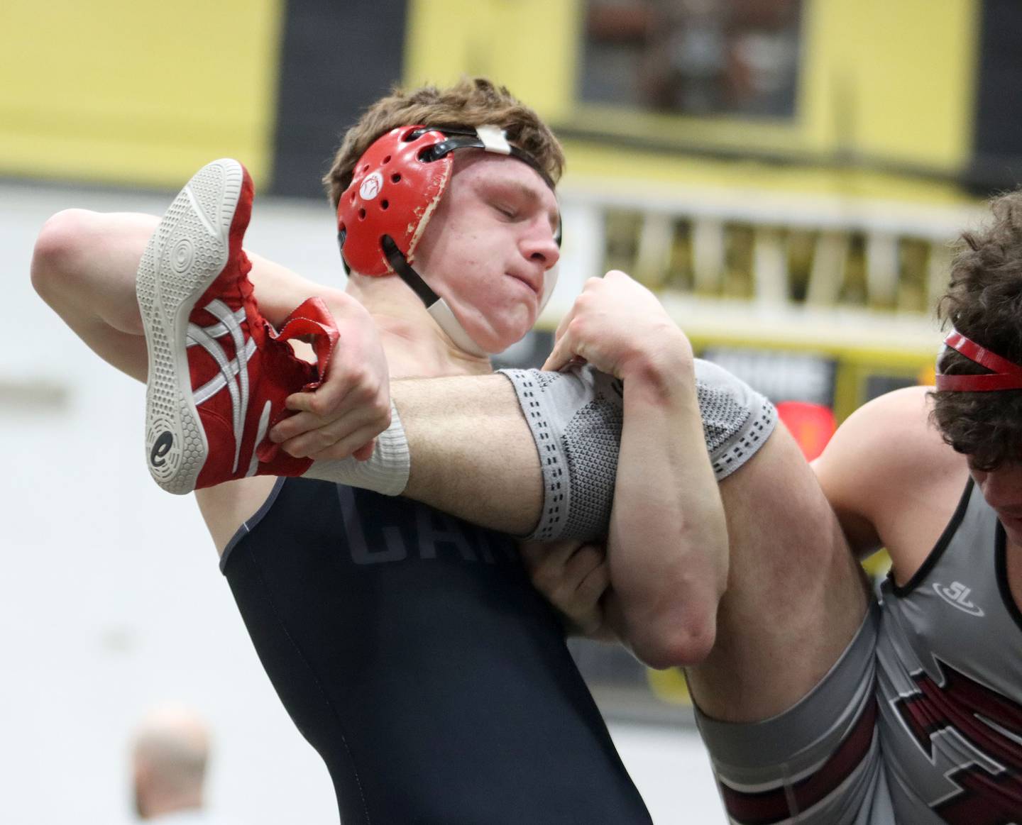 Marian’s Dan French battles Prairie Ridge’s Frank Matviychuk at 190 pounds in boys wrestling IHSA Class 2A Regional championship bout action on Saturday, Jan. 31, 2026, at Harvard High School in Harvard.