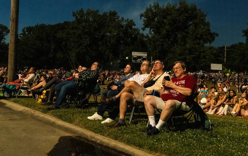 Spectators are illuminated by the “July 4th Fireworks” at Langum Park in St. Charles on Friday, July 4, 2025.