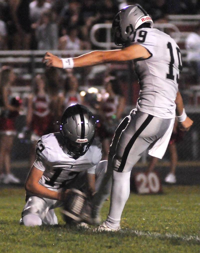Kaneland's Luke Larson holds the ball for kicker Samuel Bruno at King Field on Friday, Sept. 20, 2024.