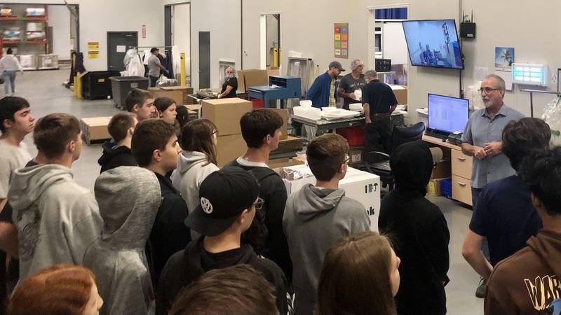 Tek Pak senior manufacturing engineer Pat Conley gives School District 303 students a tour of the factory at 707 Kautz Rd. in St. Charles on Oct. 25, 2023.