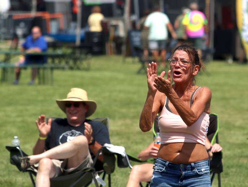 Donna Verdino of Wonder Lake grooves to the sounds of the Wall of Denial Band during the final day of Bands, Brews, and BBQ at McHenry’s Petersen Park Sunday.
