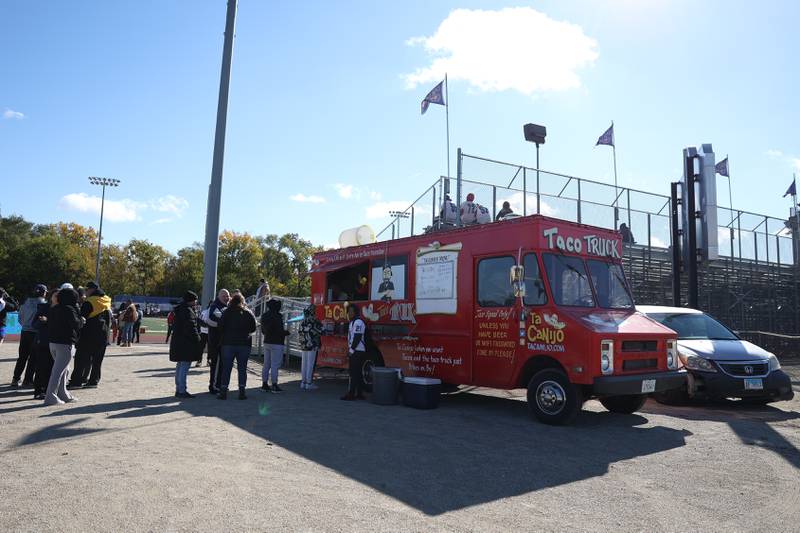 Fans line up for Ta Canijo tacos before the matchup between Joliet West and Joliet Central on Saturday.