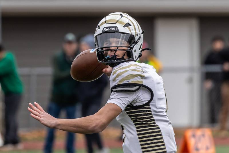 Oak Forest's Daniel Chopp looks for an open teammate during a 5A varsity football semifinal game against Providence at Providence Catholic High School on Nov. 22, 2025.