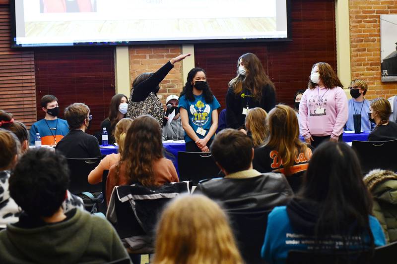 Members of Youth Engaged in Philanthropy taking part in a $100 Challenge during a monthly meeting.