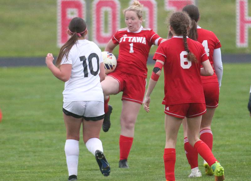 Ottawa's Bella Petty knees the ball in front of L-P's Kendal Bassett on Wednesday, April 30, 2025 at King Field in Ottawa.