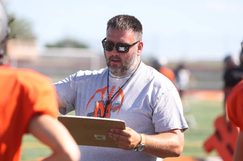 Minooka head coach Matt Harding calls out assignments during practice. Wednesday, Aug. 10, 2022, in Minooka.