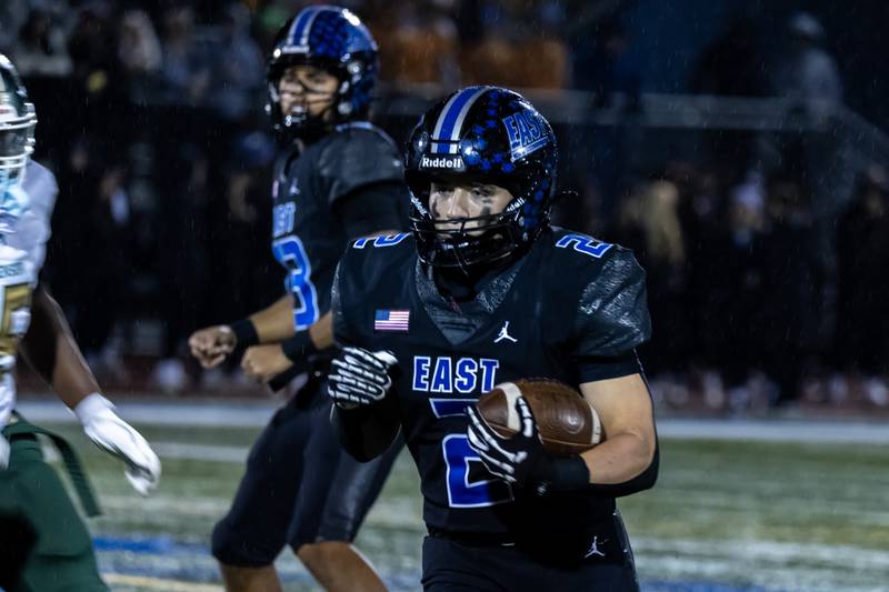 Lincoln-Way East's Brody Gish picks-up yardage during a varsity football round one playoff game against Stevenson at Lincoln-Way East on Oct. 31, 2025.
