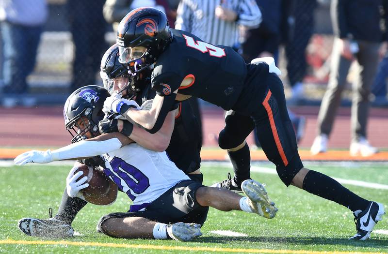 Lincoln-Way West's Cameron Kasper (5) and Joshua Veldman team up to stop Downers Grove North's Noah Battle at the 11 yard line ending a kickoff return during an IHSA Class 7A quarterfinal game on Nov. 11, 2023 at Lincoln-Way West High School in New Lenox.