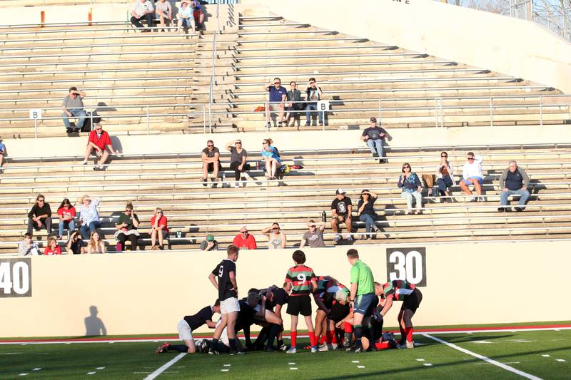 Fans watch a scrum between La Salette Academy and La-Salle Peru during a rugby game on Wednesday, April 12, 2023 at Howard Fellows Stadium at L-P High School.
