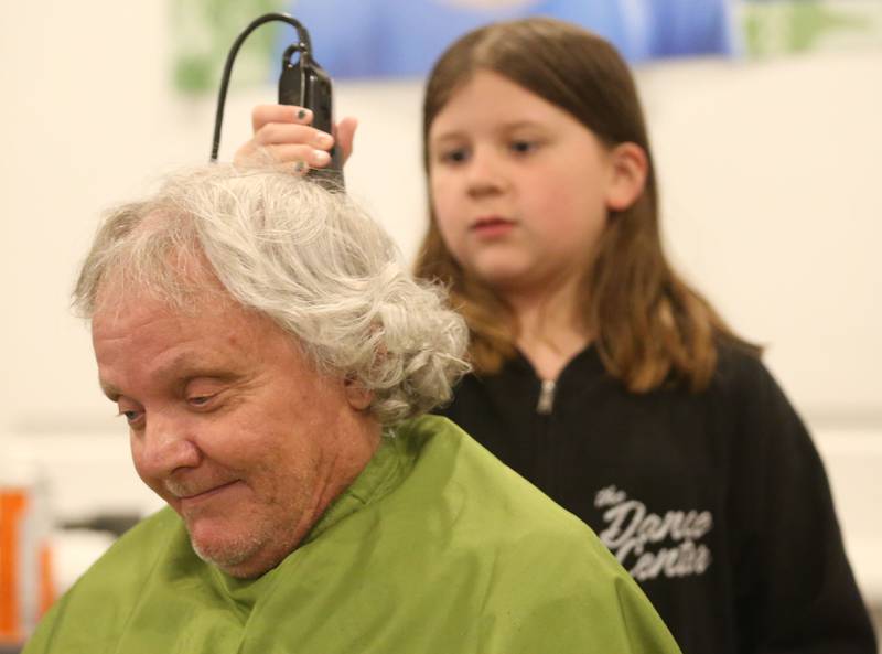 Mike Samolinski, has his head shaved by his niece Brynn Marsala during the 18th annual Illinois Valley Emergency Services St. Baldrick's event on Sunday, March 23, 2025 at Senicas Oak Ridge in La Salle.