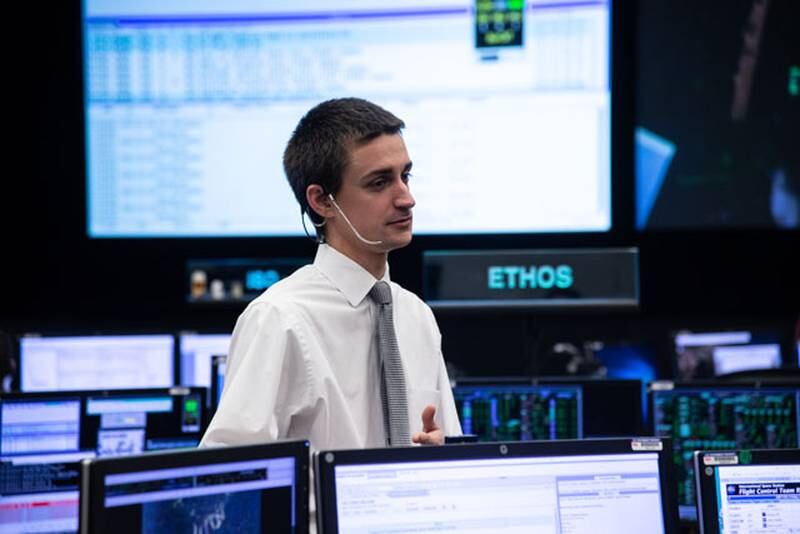 Christopher Dobbins stands at Expedition 58 flight controllers on console during release of the Northrop Grumman Cygnus CRS-10 Cargo Craft after unberthing from the nadir port of the Unity Module on the International Space Station.  Photo Date: February 8, 2019.  Location: Building 30 - FCR-1.