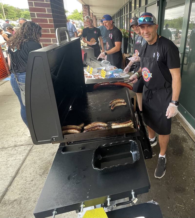 Vince Neil grills up sausages at the 25th anniversary celebration of Butcher on the Block in Lake in the Hills the weekend of Aug. 15, 2025.