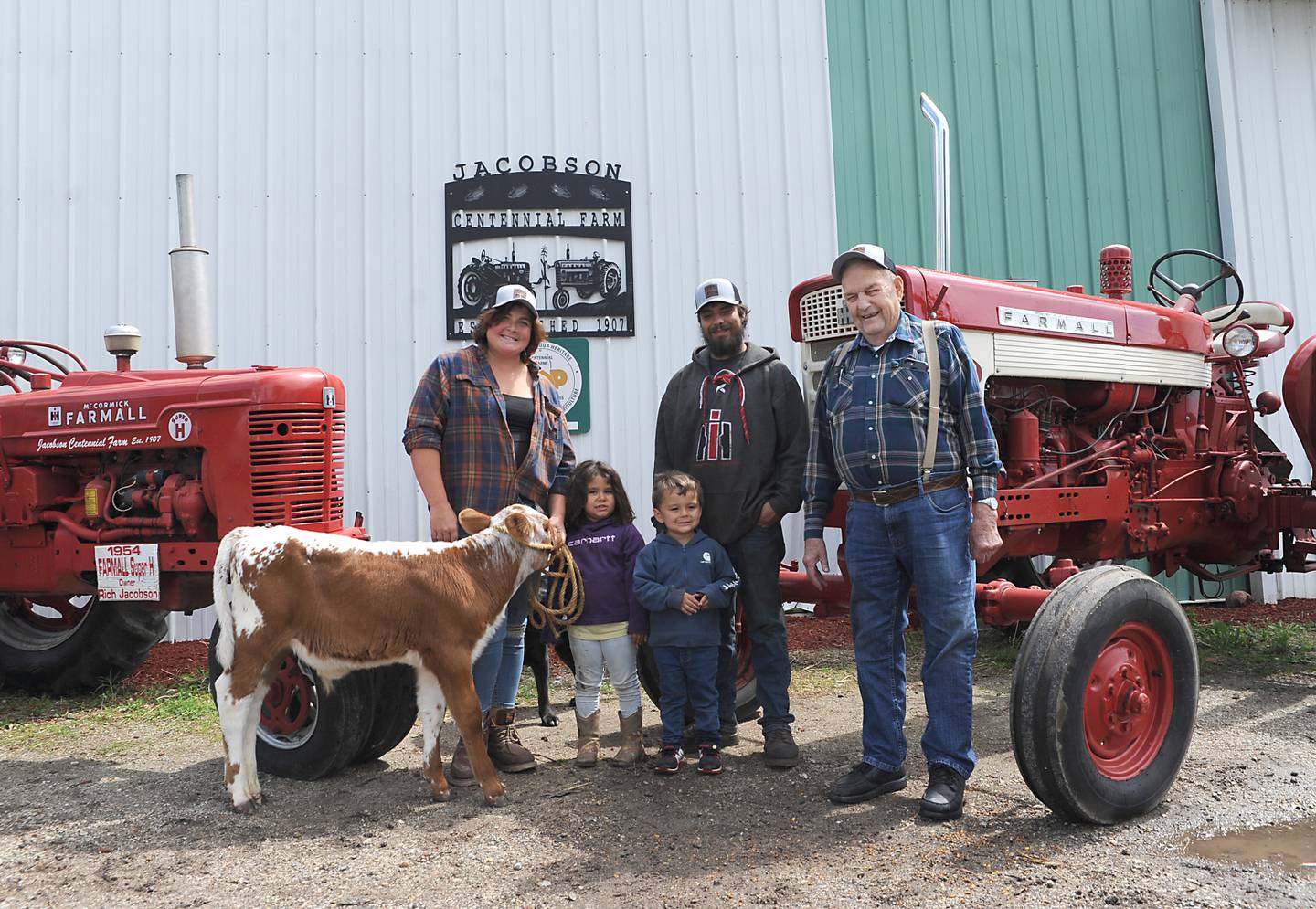 Destiny West, far left; Raylee Kelly, 4; Rich Kelly, 2; Bryon Kelly; and Richard Jacobson on Friday, June 10, 2022, at the Jacobson farm near Richmond. Bryon Kelly inherited the century-old farm from his step-grandfather Richard Jacobson.