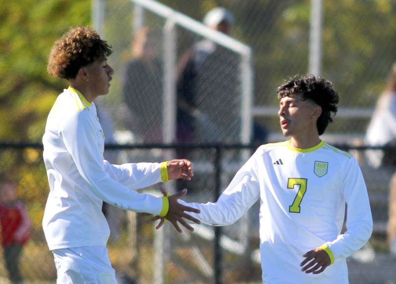 Harvard’s Jesus Aquino, right, is greeted by Bryan Gorostieta after Aquino scored against Cary-Grove in IHSA Class 2A Regional Title Game soccer action on Saturday, Oct. 26, 2024, at  Harvard Junior High School  in Harvard.