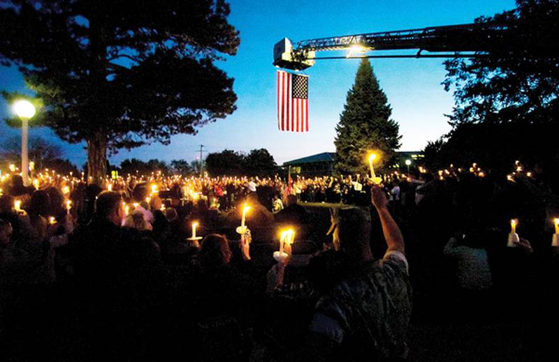 Candles are held in the air Sunday evening in memory of Marine Lance Cpl. Alec E. Catherwood of Byron. Friends of Catherwood held the ceremony that brought members of the community together to show their support.