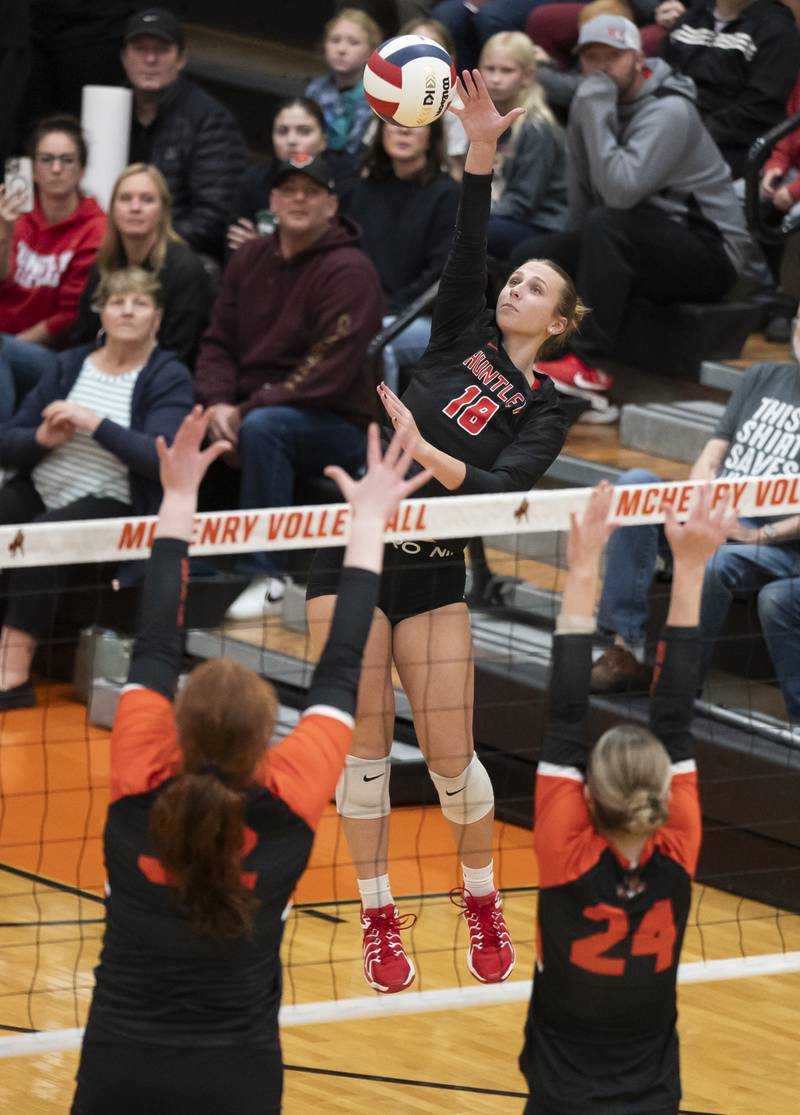 Huntley's Sienna Robertson spikes the ball as Libertyville's Grace Coughlin, left, and Makenzie Tyrrell defends during the Class 4A Sectional girls volleyball final on Thursday, November 7, 2024 at McHenry High School. Ryan Rayburn for Shaw Local