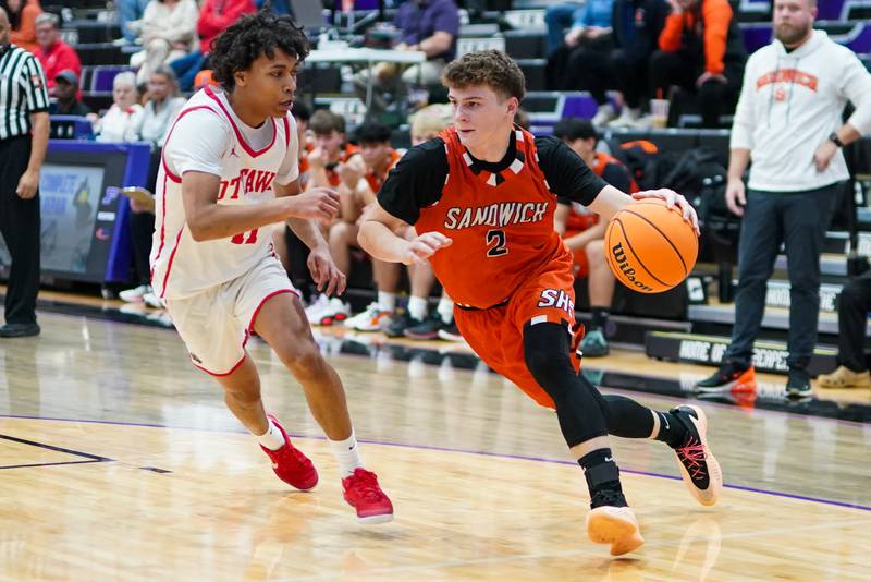 Sandwich's Griffin Somlock (2) drives the baseline against Ottawa’s Khezekiah Joachim (11) during a basketball game in the opening round of the 61st annual Plano Christmas Classic at Plano High School on Monday, December 23, 2024.