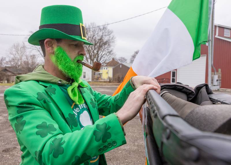 Chris Duncan prepares a vehicle with decorations prior to the start of the St. Patrick's Day Parade on March 7, 2026 in Utica.