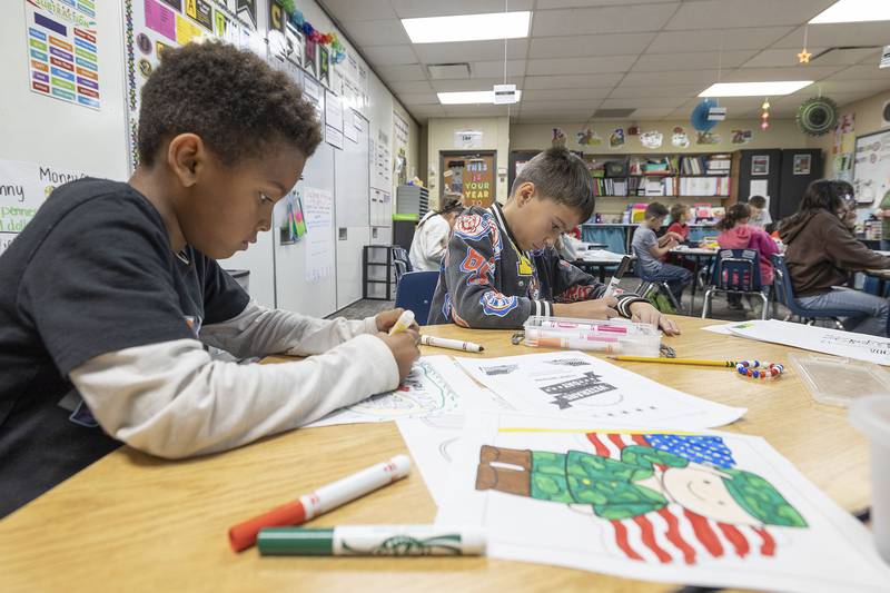 Students color in pictures for the Valor Support Project Monday, Nov. 10, 2025, at Merrill School in Rock Falls. The project helps raise money and awareness for veterans in need.