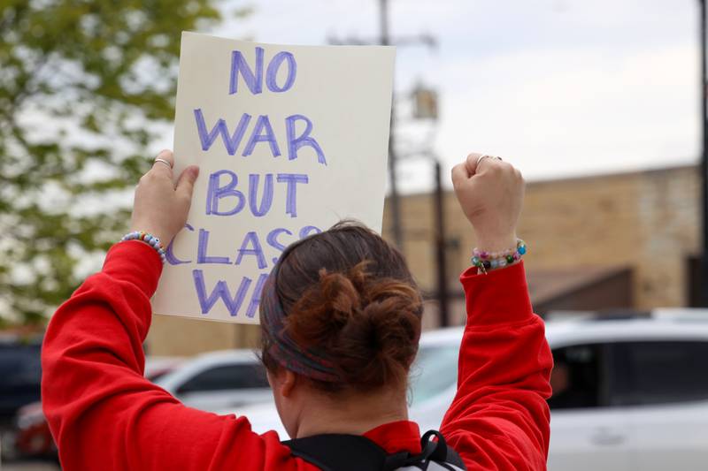A protester interacts with a supportive passerby during the May Day Strong rally at the Kankakee County Courthouse on May 1, 2026, as part of a national day of action.