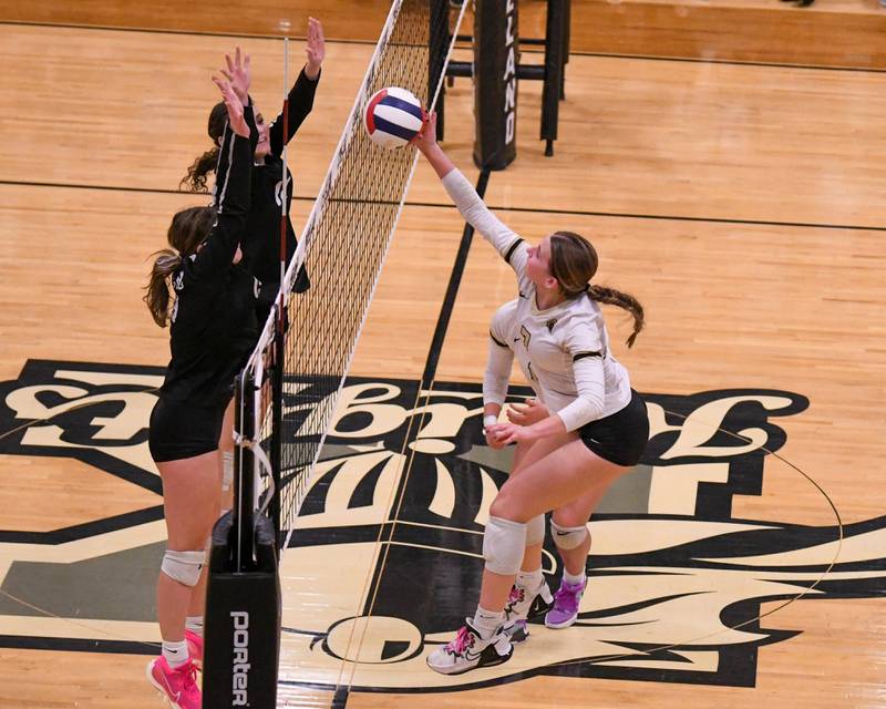 Kaneland Adalynn Ruh, left, tries to block the spike of Sycamore Laci Neece (7) during the first of two games on Thursday Oct. 19, 2023, held at Kaneland High School.