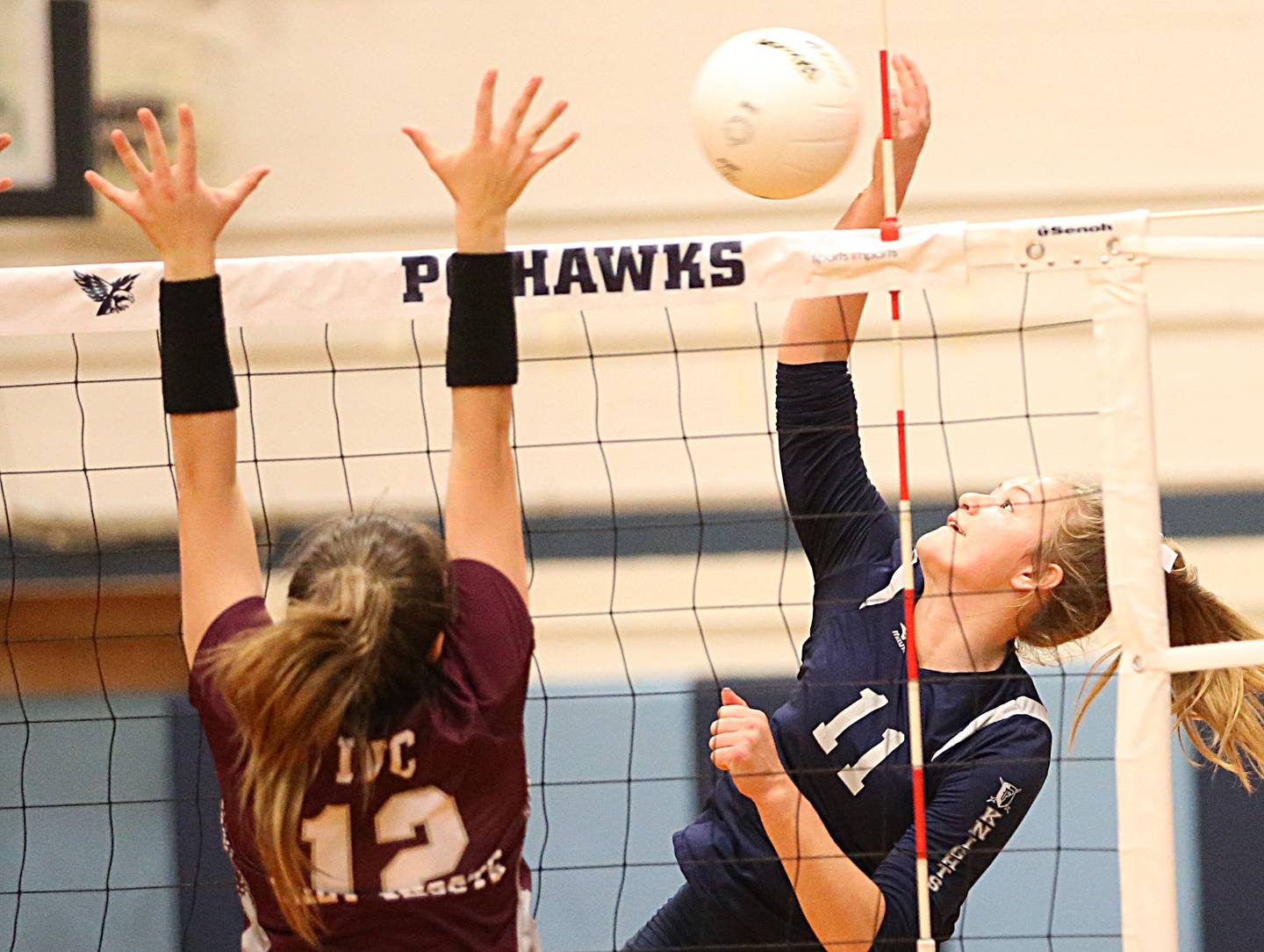 Fieldcrest's Allie Wiesenhofer sends the ball past IVC's Laila Peterson in the Class 2A Sectional volleyball final at Prairie Central High School on Wednesday, Nov. 2, 2022 in Fairbury.